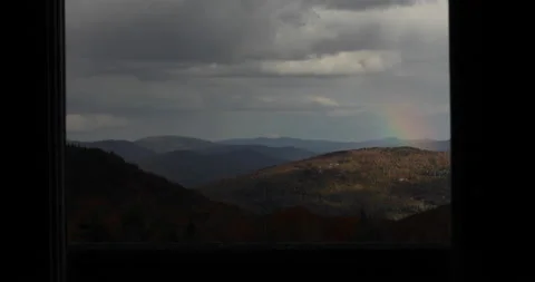 Looking at a rainbow out the window in the mountains. Stock Footage 148166275