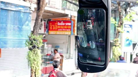 Looking into the rear view mirror of a bus in a traffic jam Stock Footage 237139418