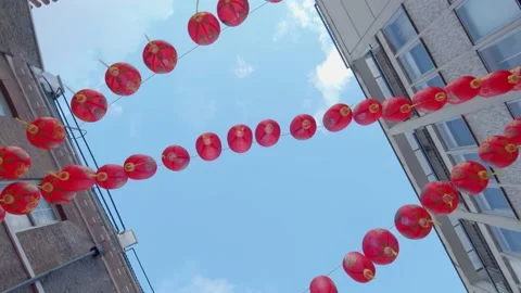 Looking up at red Chinese lanterns dangling in Chinatown in London Stock Footage 148617074