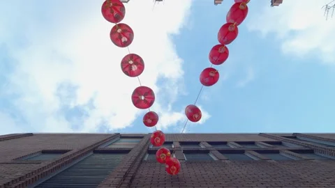 Looking up at red Chinese lanterns dangling in Chinatown in London Stock Footage 148617852