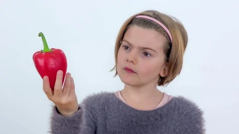 Looking at a red pepper in her hand Stock Footage 83724723