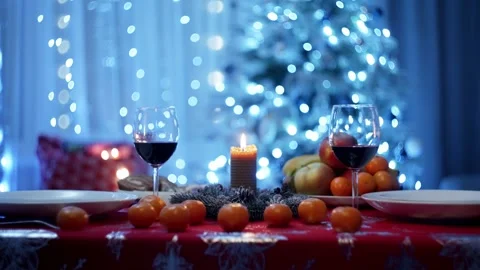 Looking at the reflection of the candle on the festive table, you feel the magic Stock Footage 259085163