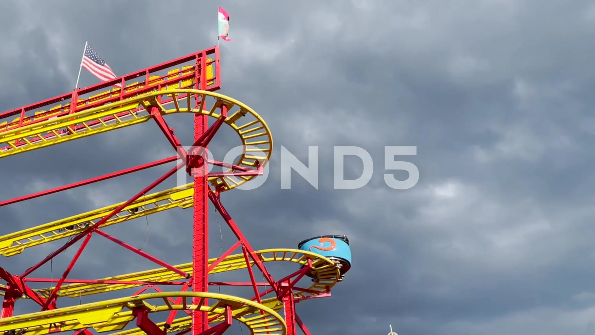 Looking up at a roller coaster ride with scary dark sky