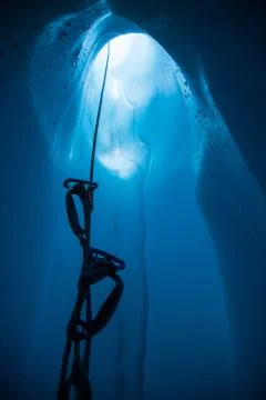 Looking up rope with ascenders from inside a deep moulin ice cave in teh Mata Stock Photos