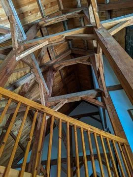 Looking up at Rustic Timber Beams &amp; a Second Floor Railing in a Log Cabin Stock Photos