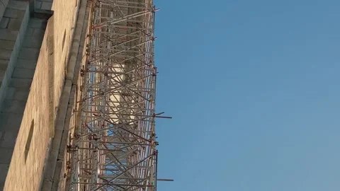 Looking up into scaffolding against a stone facade Stock Footage 235927867