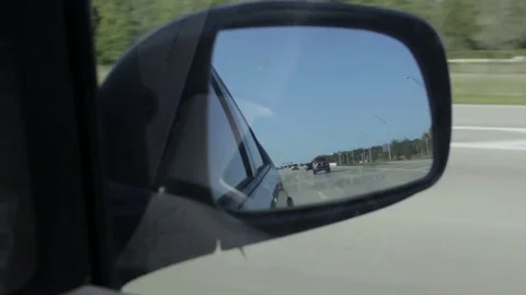 Looking in Side Car Mirror while Driving Stock Footage 74279780