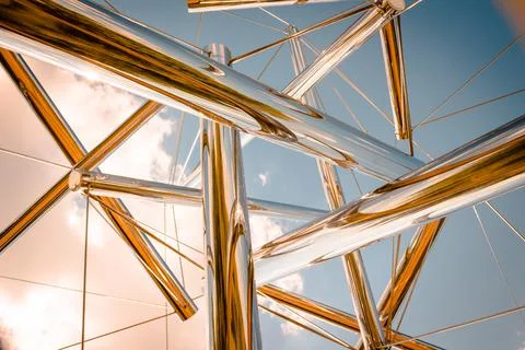 Looking up at the sky through an abstract chrome statue Stock Photos