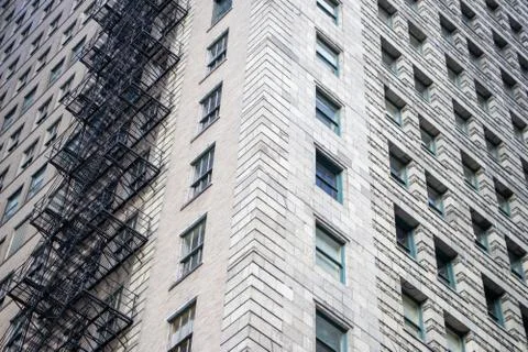 Looking up at a skyscraper in Chicago, IL with a fires escape on its side. Stock Photos