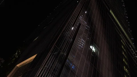Looking up at skyscraper at night. Lights showing elevators going up. Tokyo. Stock Footage 247962968