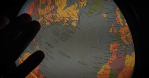 Looking for something and pointing fields on rotating earth globe Video stock 232316922