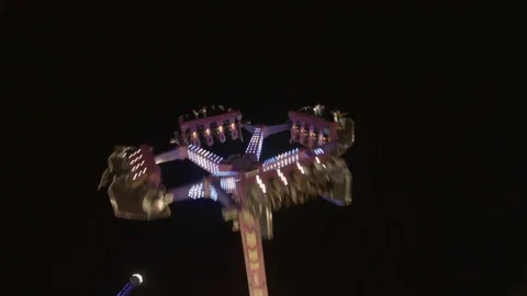 Looking up at spinning pendulum at night Stockbeeldmateriaal 83541931