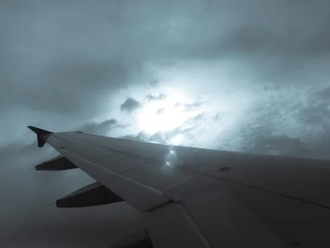Looking storm through window aircraft in wing aerial view of landscape and sk Stock Photos