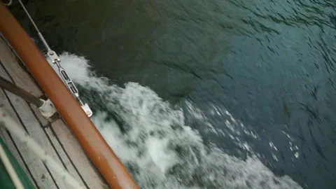 Looking straight down the side of the boat flowing thru the water Video stock 146191476