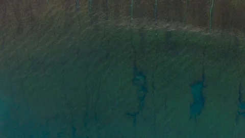 Looking straight down at waves breaking over a tropical reef Stock Footage 93782073
