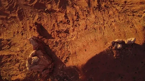 Looking straight down while flying over rocky desert landscape Stock Footage