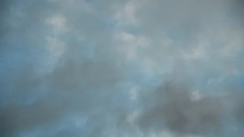 Looking straight up into a teal blue sky filled with translucent white and gray  Stock Footage 140937378