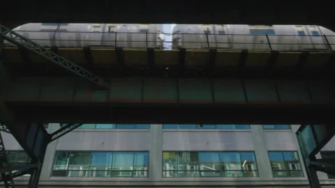Looking up from the street as a subway train passes directly above Stock Footage 275607712
