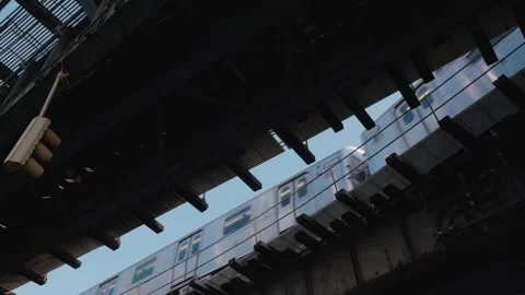Looking up as the subway passes on above ground tracks Stock Footage 275798262