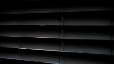 Looking at sunset through window closed by blinds. Close up view Stock-Footage 294143636