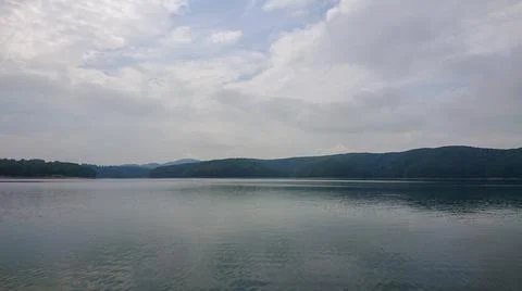 Looking at the surface of a large and beautiful mountain lake Stock Photos