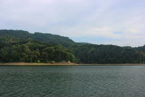 Looking at the surface of a large and beautiful mountain lake Stock Photos