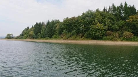 Looking at the surface of a large and beautiful mountain lake Stock Photos