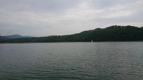 Looking at the surface of a large and beautiful mountain lake Stock Photos