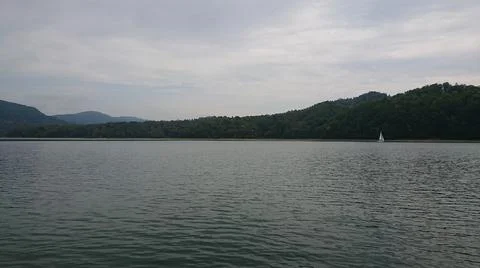 Looking at the surface of a large and beautiful mountain lake Stock Photos