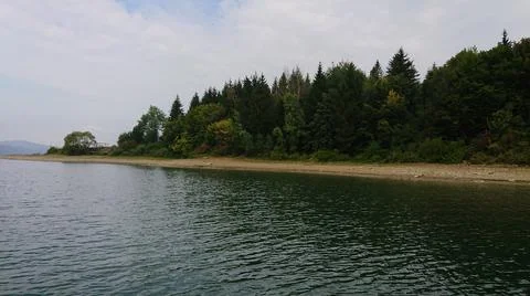 Looking at the surface of a large and beautiful mountain lake Stock Photos