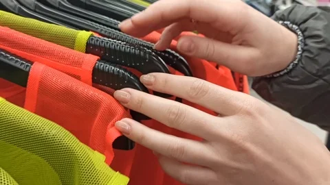 Looking for t-shirts on a hanger in a store Stock Footage 124401352
