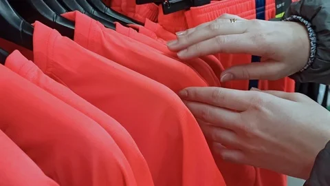 Looking for t-shirts on a hanger in a store Stock Footage 124401451