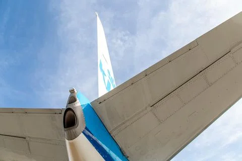 Looking up to the tail and stabiliser of a blue aircraft Stock Photos