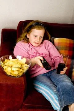 Looking television modern life while looking television with junkfood and ... Stock Photos