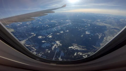 Looking Through Aircraft Plane Window Overlooking Clouds Sky in Flight Stock Footage 103587264