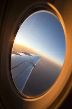 Looking through airplane window at sunset Photos