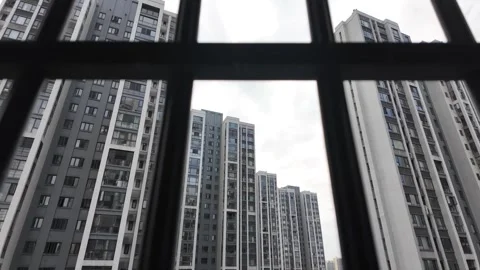 Looking through a balcony window with metal bars of apartment buildings Vídeos de archivo 295253114