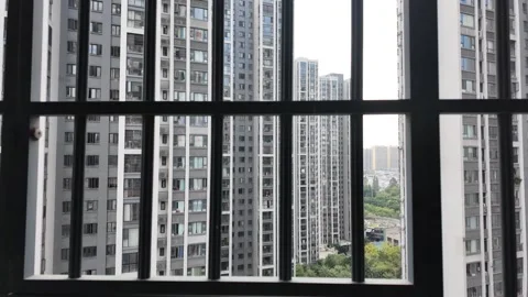 Looking through a balcony window with metal bars from an apartment building Stock Footage 295253386