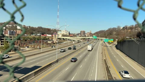 Looking through a broken fence at the freeway Stock Footage 256950825