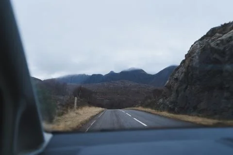 Looking through car windshield towards mountains Stock Photos