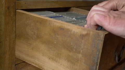 Looking through CDs in drawer.	 Stock-Footage 134613534