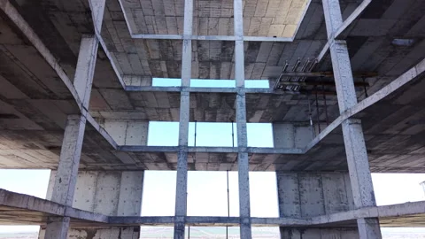 Looking up through central void of concrete building frame 스톡 동영상 334312641