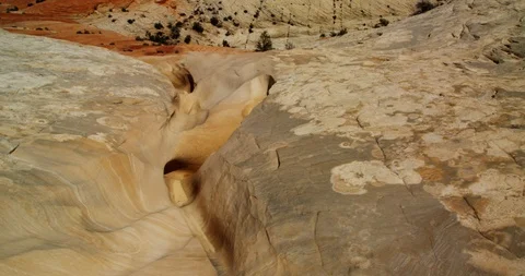 Looking through a desert sandstone wash to snowcapped mountains, Utah Stock Footage 124497892