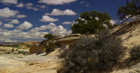 Looking through a desert sandstone wash to snowcapped mountains, Utah Stock Footage 124604929