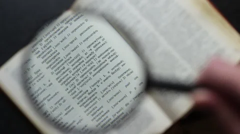 Looking through the English-Russian dictionary with a magnifying lens 動画素材 66753636