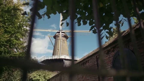 Looking through a fence towards the old Dutch windmill "de hoop" Stock Footage 85214853