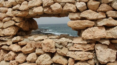 Looking Through A Gap Wall At Rocks With Sea Stock Footage 36556224