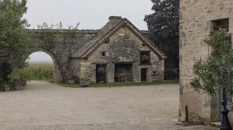 Looking through a gateway at a stone built shed Stock Photos