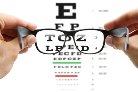 Looking through the glasses at eye chart Stock Photos