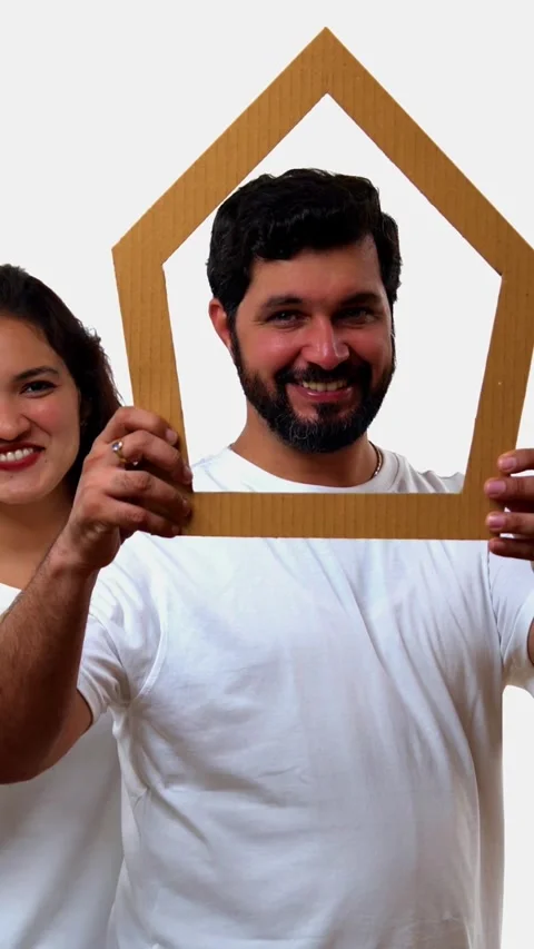 Looking through house cutout, Indian couple promotes dream home Stockbeeldmateriaal 343163930